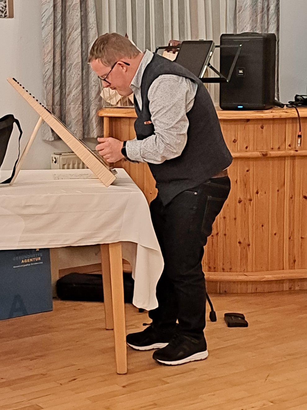 Mann spielt auf seiner Tisch-Harfe